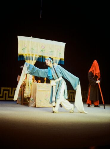 a man and a woman in costume on a stage