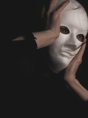 person in black long sleeve shirt covering face with face