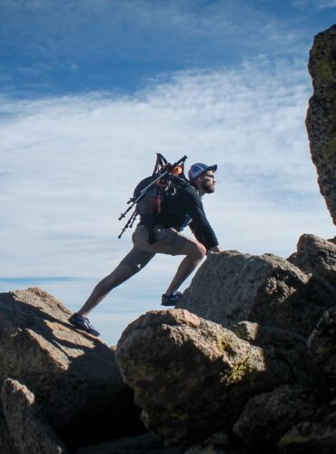 photo of man climbing mountain