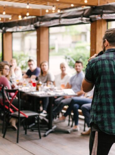 man standing infront of group of people