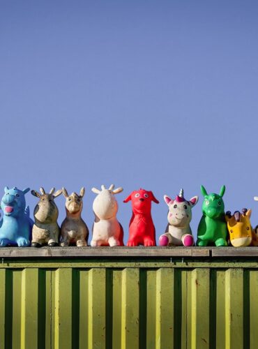 a group of toy animals sitting on top of a green container