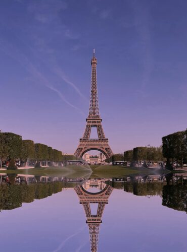 the eiffel tower is reflected in the water